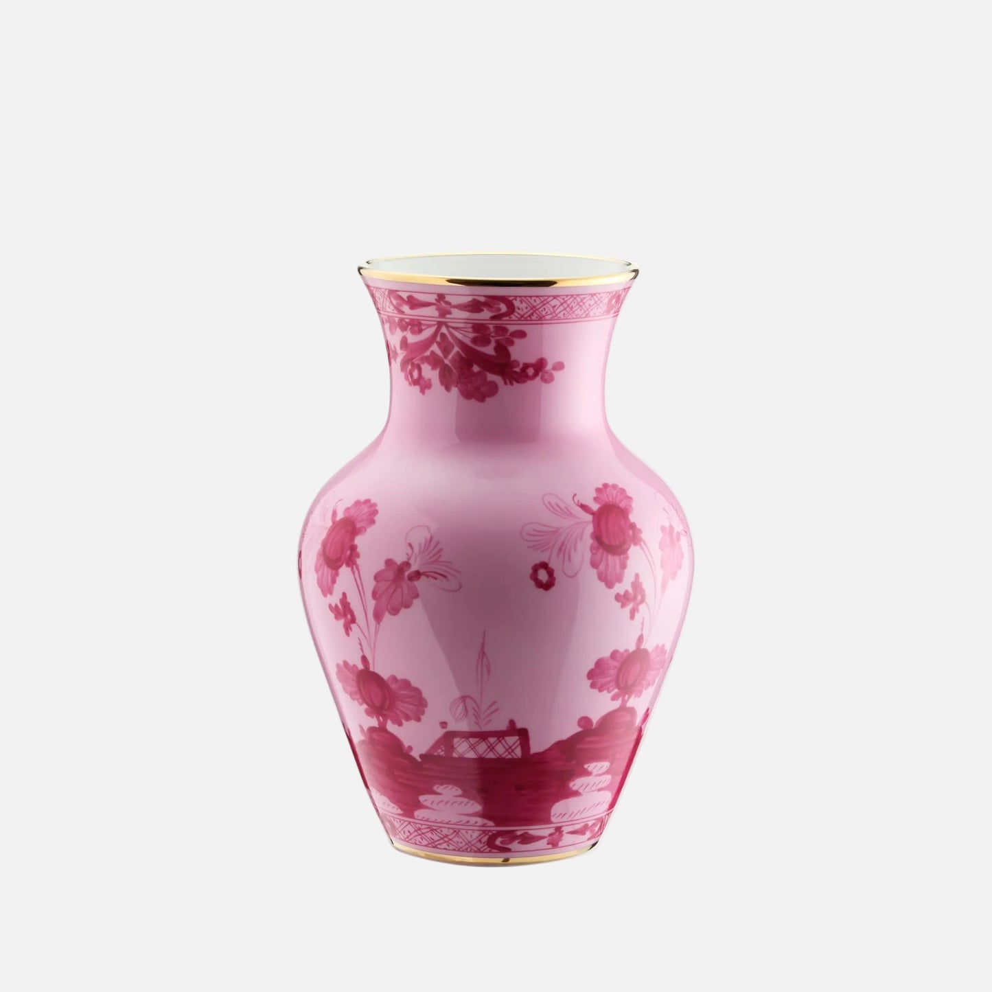 A pink ceramic vase with a dark red floral and landscape pattern, featuring gold trim on the rim and base, set against a plain white background.