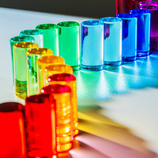 Colorful blocks arranged in a row on a reflective surface.