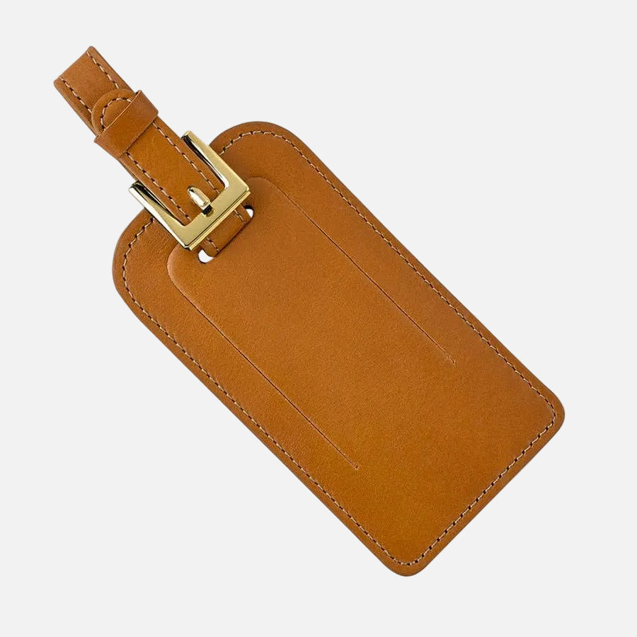 Brown leather luggage tag with a gold buckle on a white background