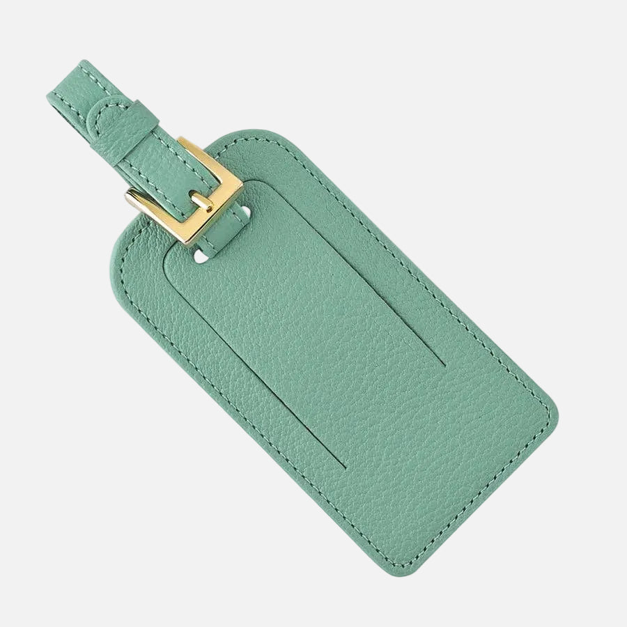 Green leather luggage tag with a gold buckle on a white background