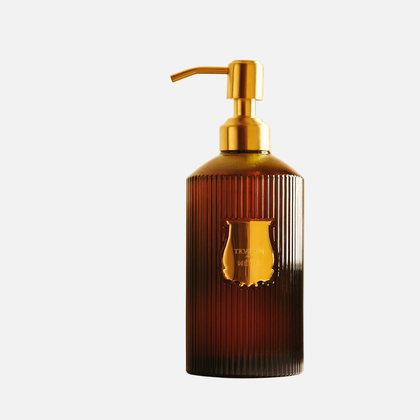 Brown bottle with gold pump on a white background