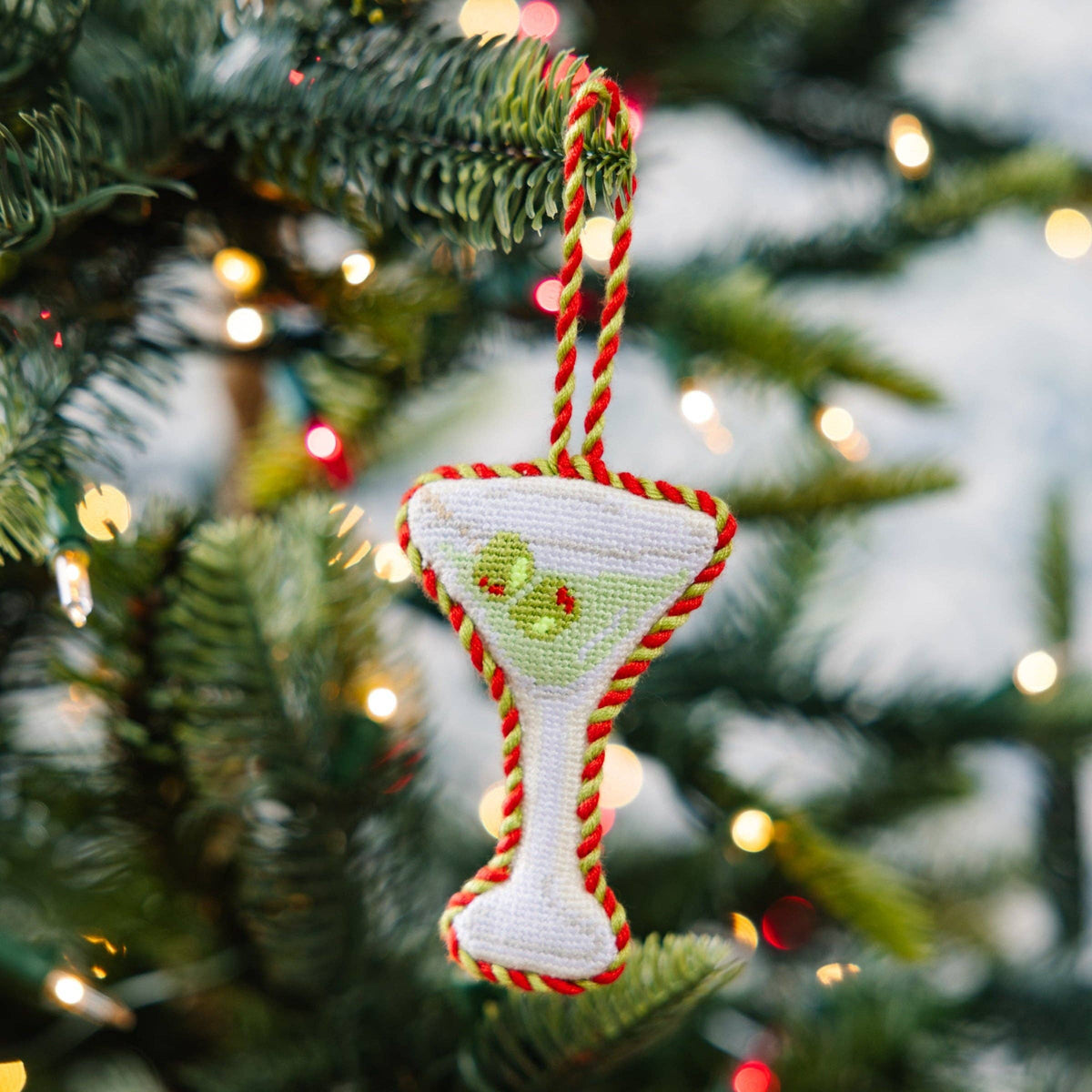 Decorative Christmas ornament shaped like a martini glass on a Christmas tree.