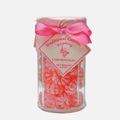 Candle in a glass jar with a pink bow and label on a white background