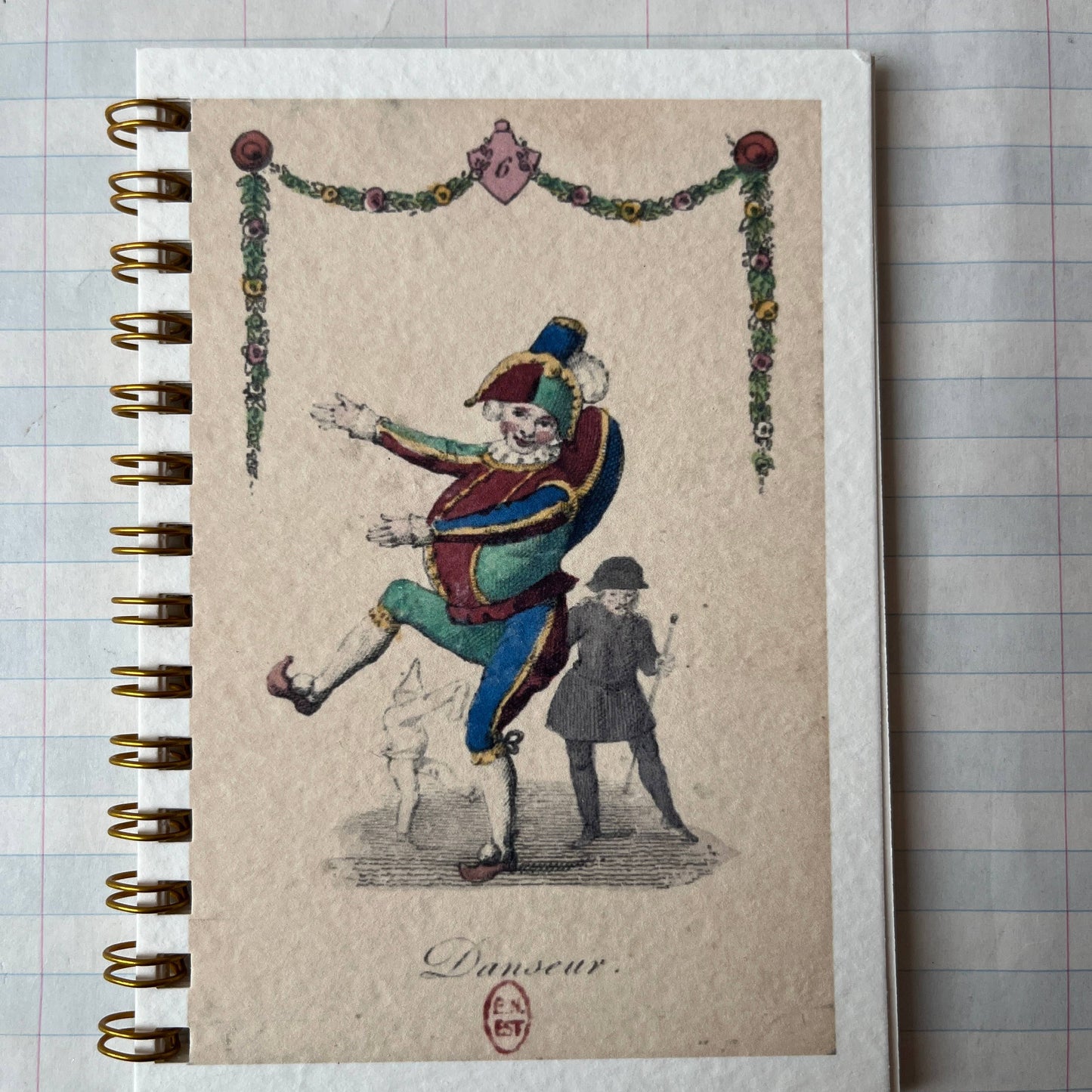 Notebook with a vintage illustration of a clown on a textured surface