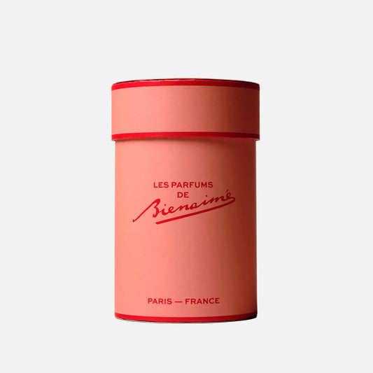 Pink cylindrical container with red lid featuring 'Les Parfums de Bienaimé' branding on a light gray background.