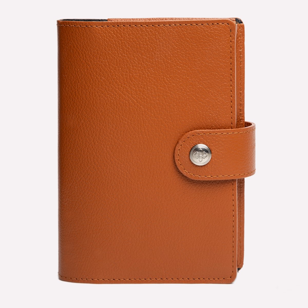 Brown leather notebook with a silver button on a white background