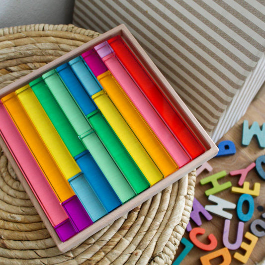 Colorful wooden blocks and magnetic letters on a wooden surface