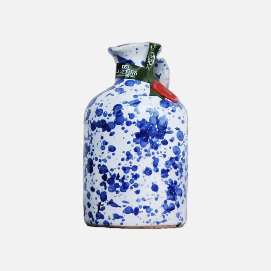 White container with blue floral pattern and red label on a white background