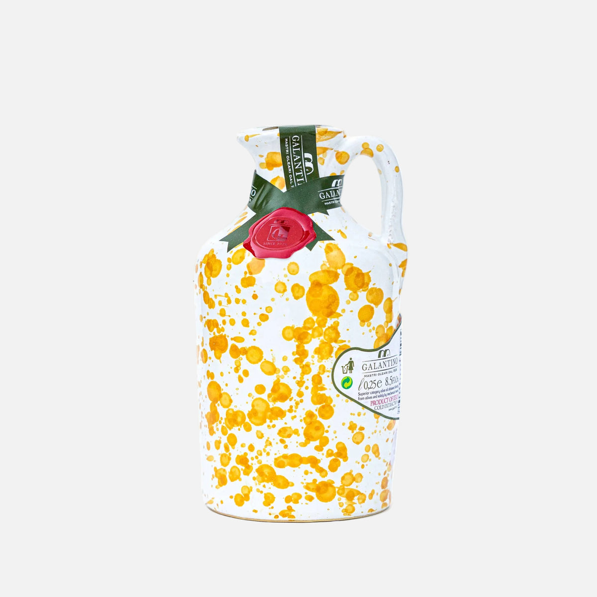 Decorative milk jug with floral design and brand label on a white background