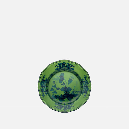 A green ceramic plate with a scalloped rim and a dark blue landscape illustration printed on the inside, shown against a plain white background.