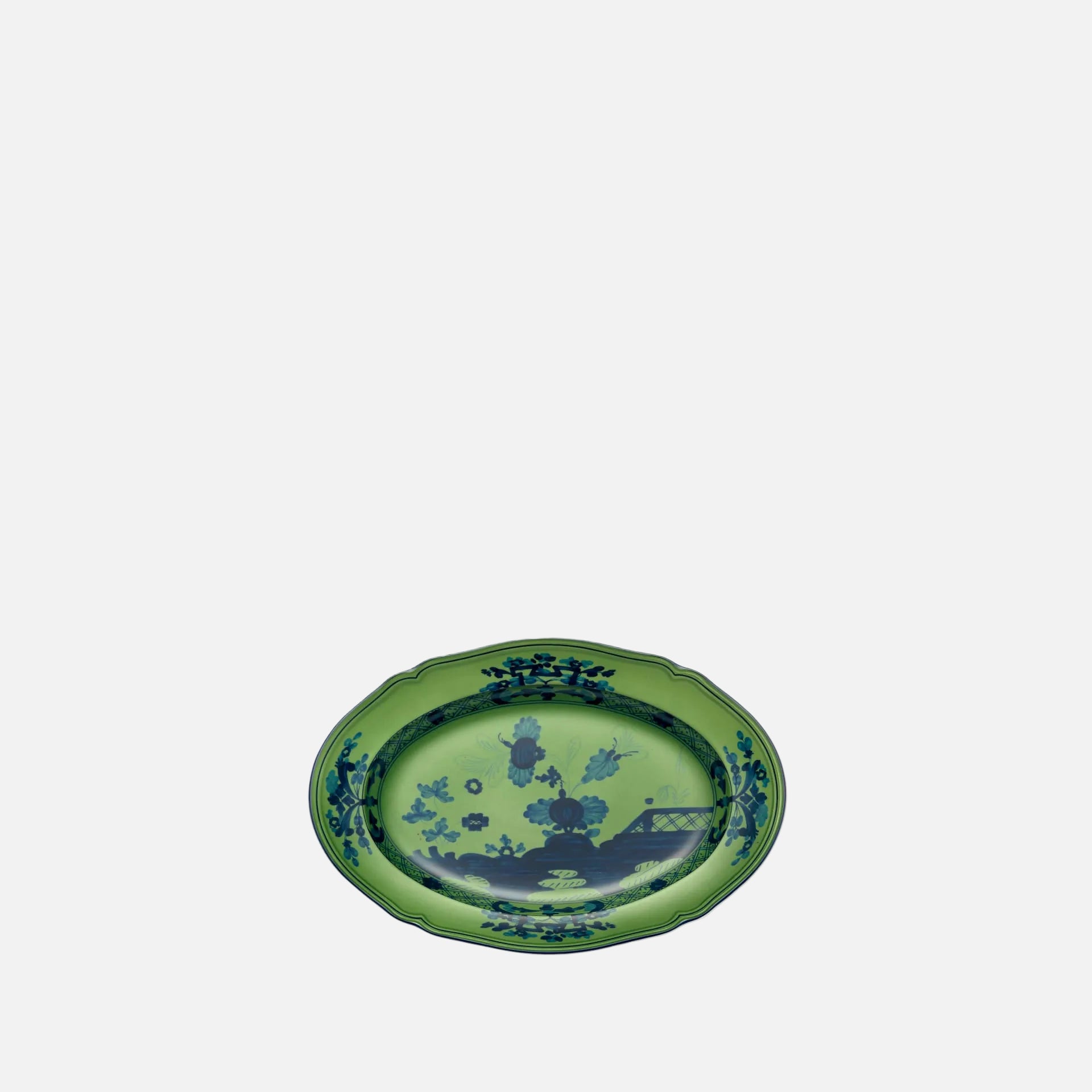 An oval green ceramic serving platter with a blue landscape illustration and decorative border, shown on a plain white background.