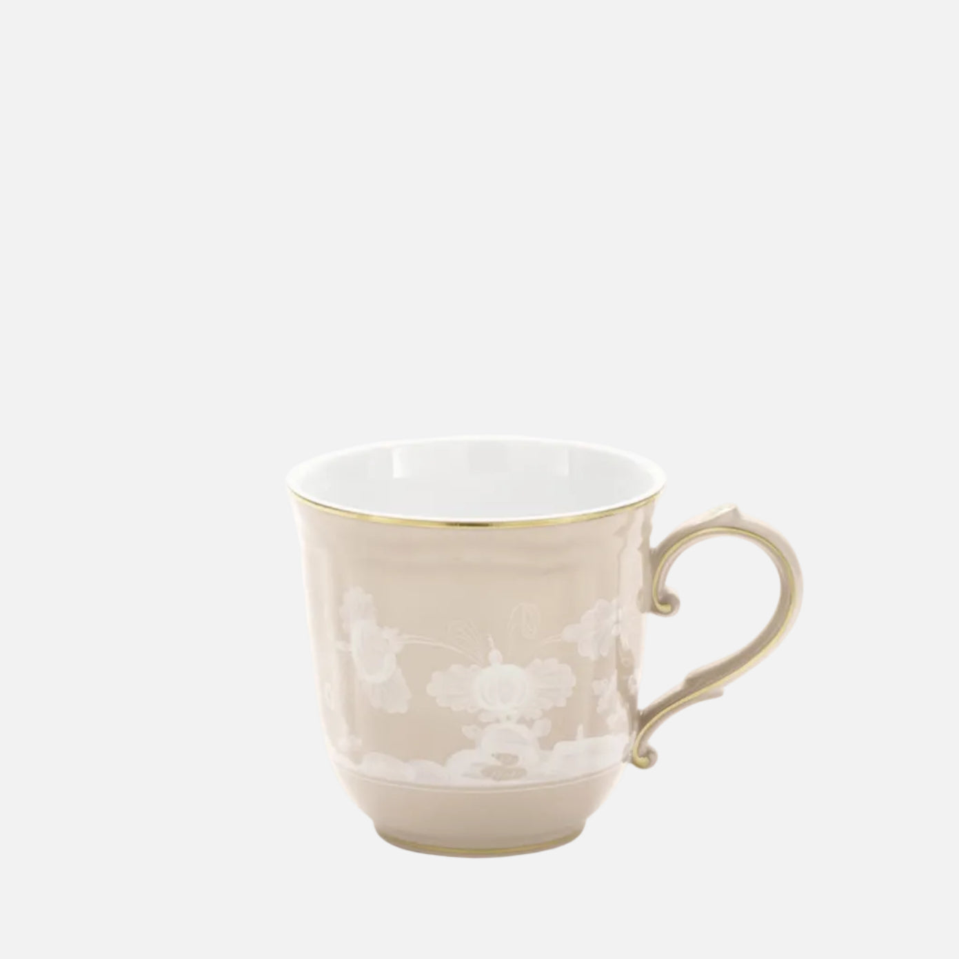 A classic ceramic teacup in a warm beige color with delicate white floral patterns and a thin gold rim, set against a plain white background.
