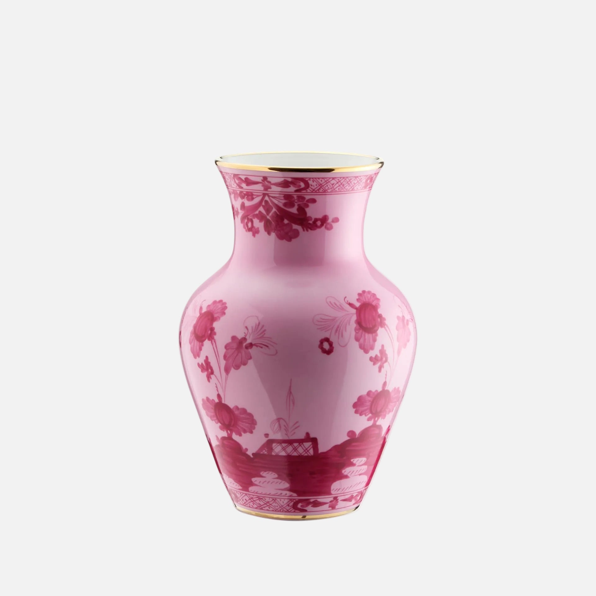 A pink ceramic vase with a dark red floral and landscape pattern, featuring gold trim on the rim and base, set against a plain white background.