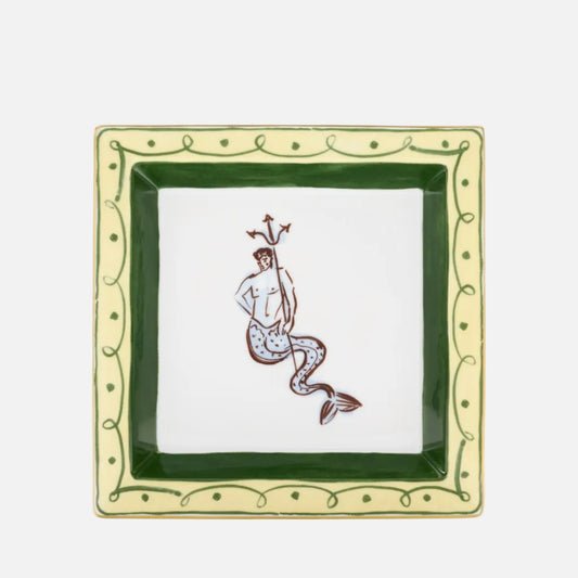 A square ceramic dish featuring a white center with a brown line-art illustration of a mermaid, surrounded by a dark green inner border and a light green outer border with decorative leaf and dot patterns.