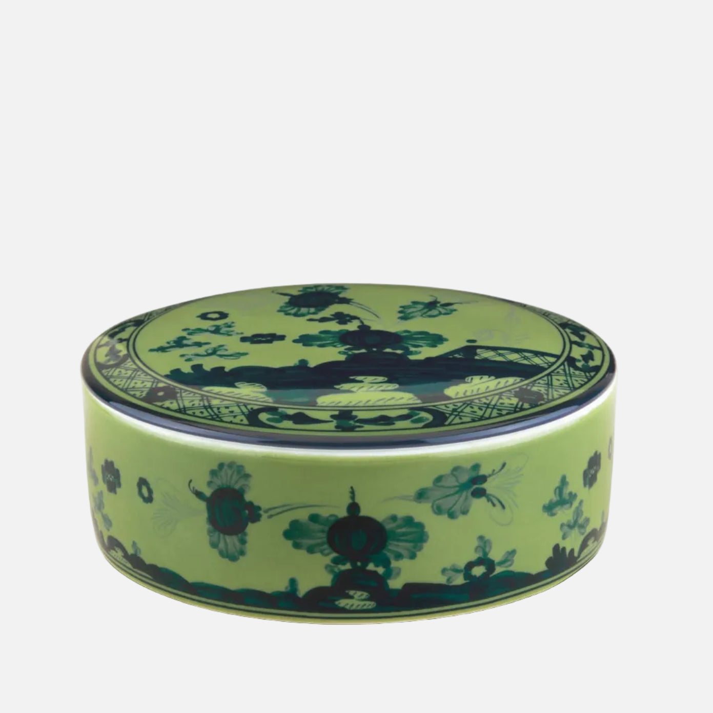 A round ceramic lidded box with a light green body and lid, decorated with dark green and black floral and landscape motifs, shown on a white background.