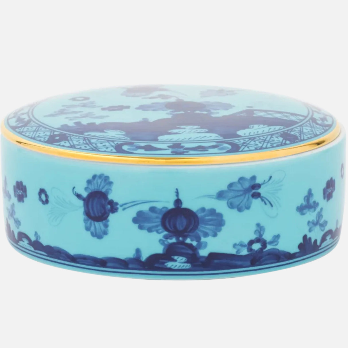 A round ceramic lidded box with a light blue body and dark blue floral and landscape patterns, accented by a thin gold rim, shown on a white background.