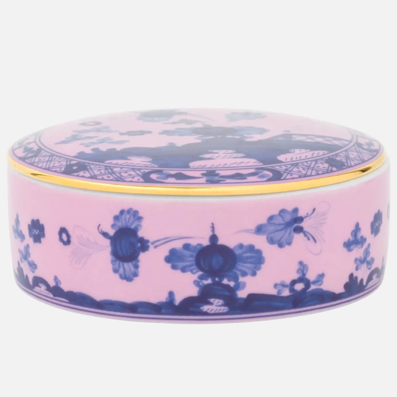 A round pink ceramic box with a matching lid, decorated with blue floral and landscape motifs and a thin gold rim, shown on a white background.