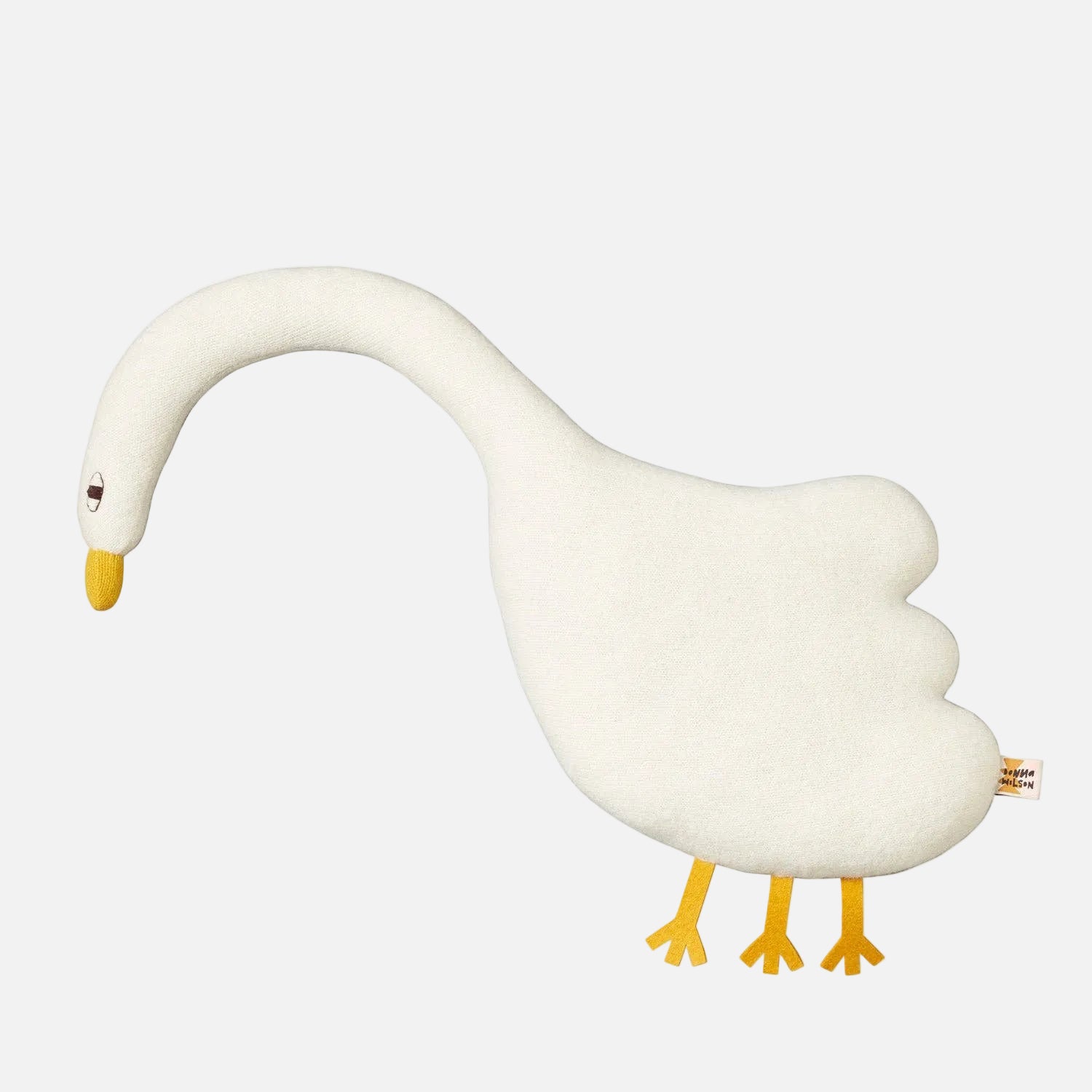 White goose-shaped pillow with yellow feet and beak on a white background