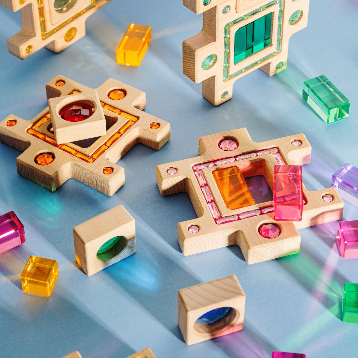 Colorful wooden building blocks on a reflective surface