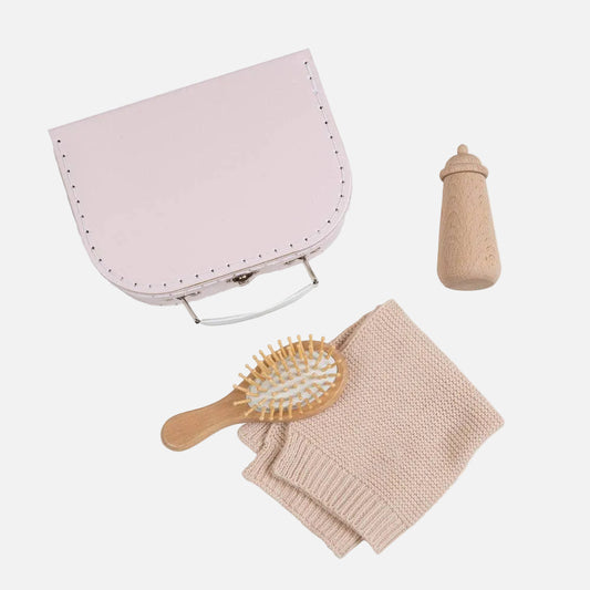 Baby care items including a pink bag, bottle, brush, and blanket on a white background