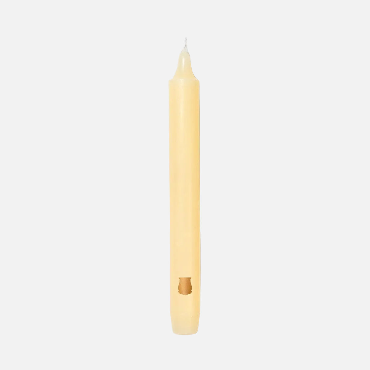 Ivory candle on a light gray background