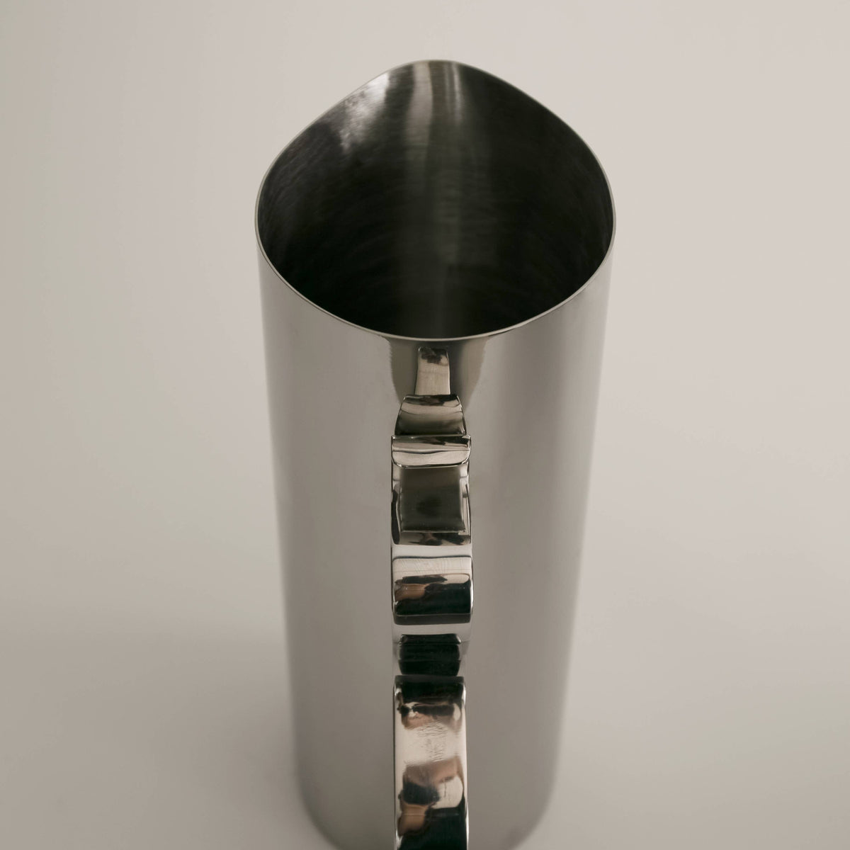 Metallic cocktail shaker on a light gray background