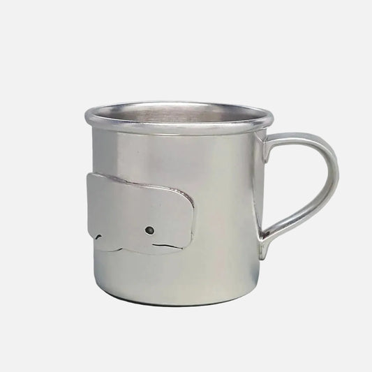 Silver cup with a whale design on a light gray background