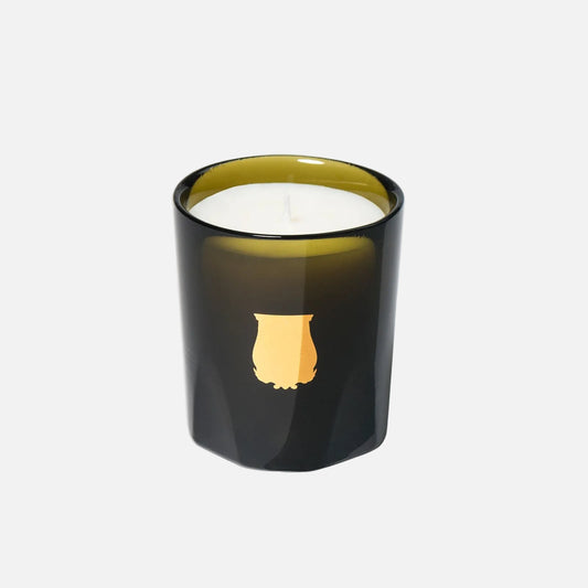 Black candle with a gold emblem on a white background
