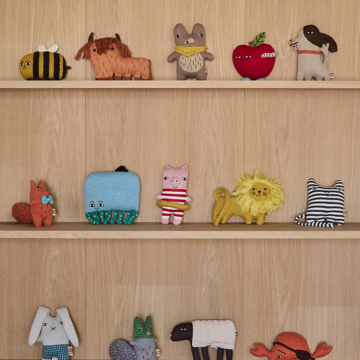 Collection of small animal figurines on a wooden shelf