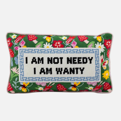 Decorative pillow with floral pattern and text 'I AM NOT NEEDY I AM WANTY' on a white background
