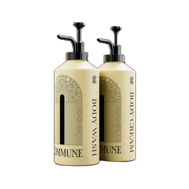 Two cream-colored pump bottles of Commune body wash and body cream with black pumps, shown on a plain white background.