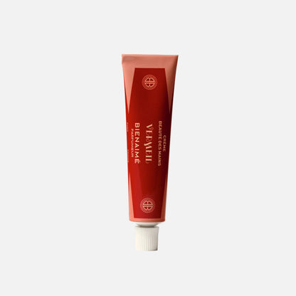 Red tube of Benaime hand cream on a light gray background