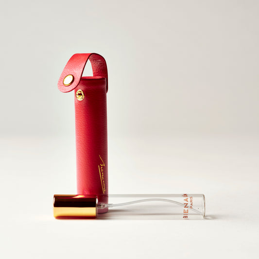 Red lip balm case with clear lip balm on a light gray background