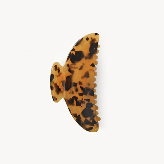 Tortoiseshell butterfly-shaped hair clip on a white background