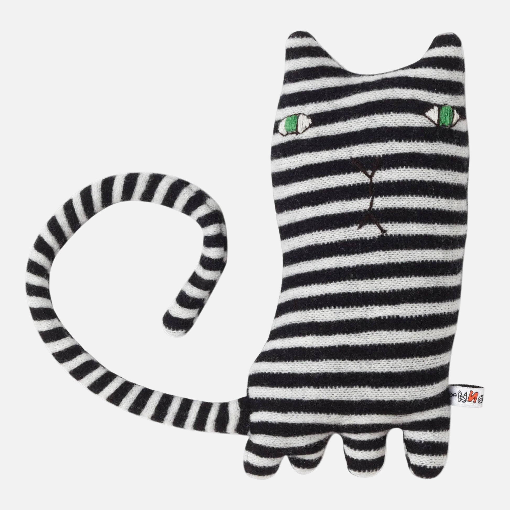 Black and white striped cat-shaped toy with green eyes on a white background