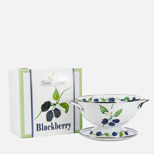 Decorative bowl with blackberry design next to a branded box on a white background