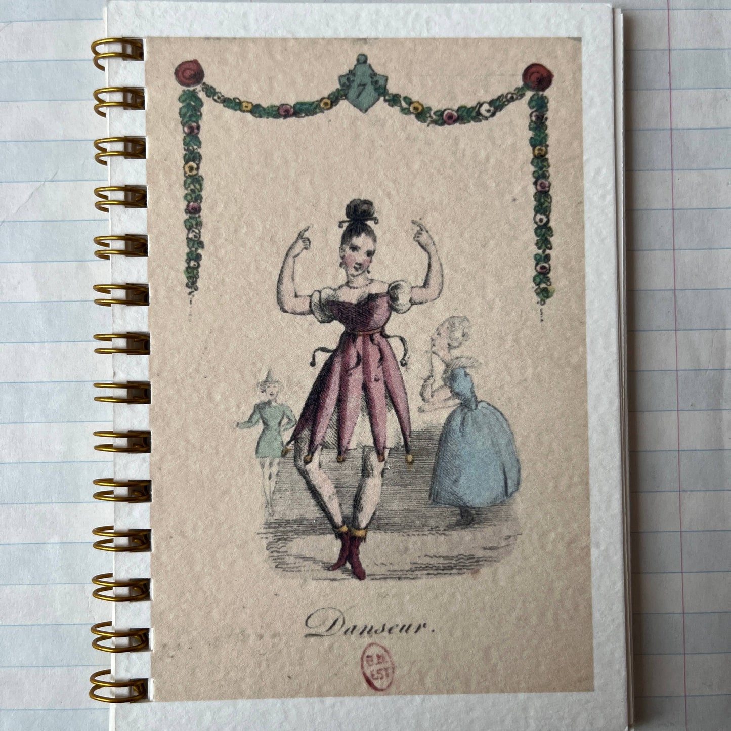 Notebook with vintage-style illustration on a textured surface
