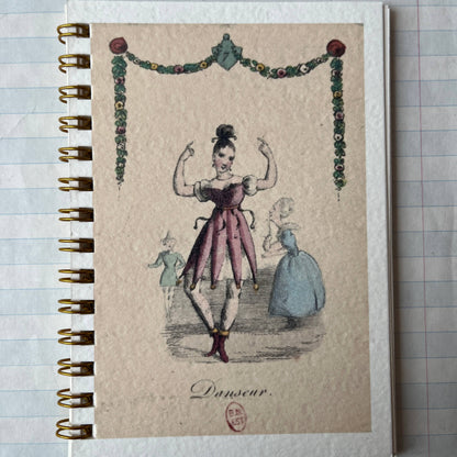 Notebook with vintage-style illustration on a textured surface