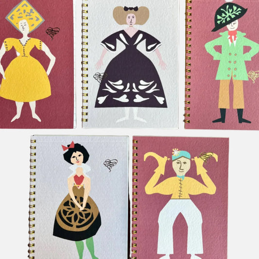 Five notebooks with illustrated covers of people in vintage attire on a wooden surface.
