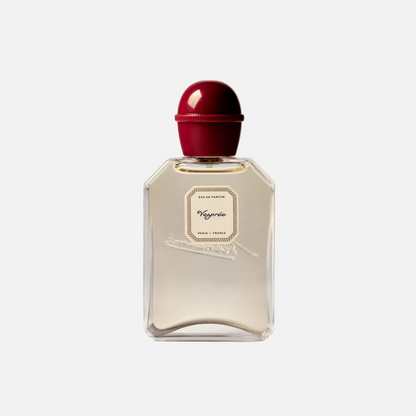 Perfume bottle with a red cap on a light gray background