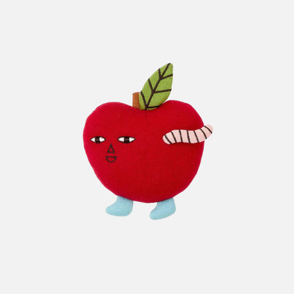 Toy apple with a face and leaf on a white background