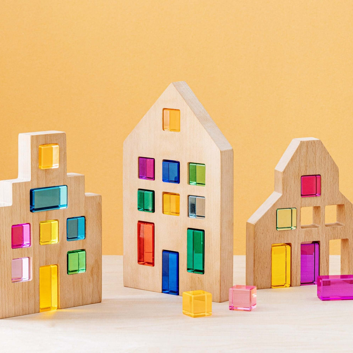 Wooden houses with colorful transparent windows on a yellow background