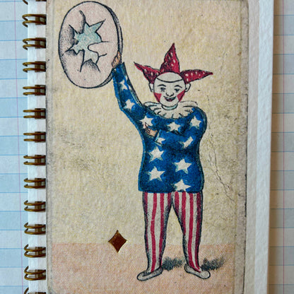 Notebook with a clown illustration on a textured surface