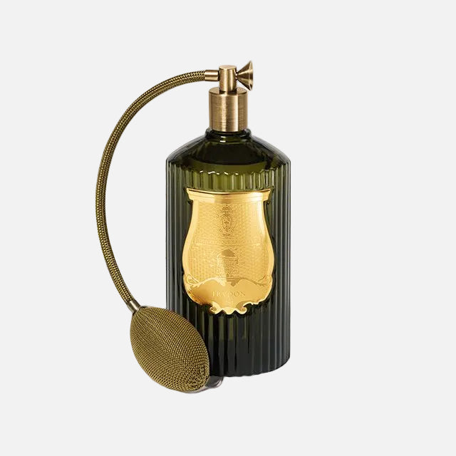 Perfume bottle with gold cap and black body on a white background
