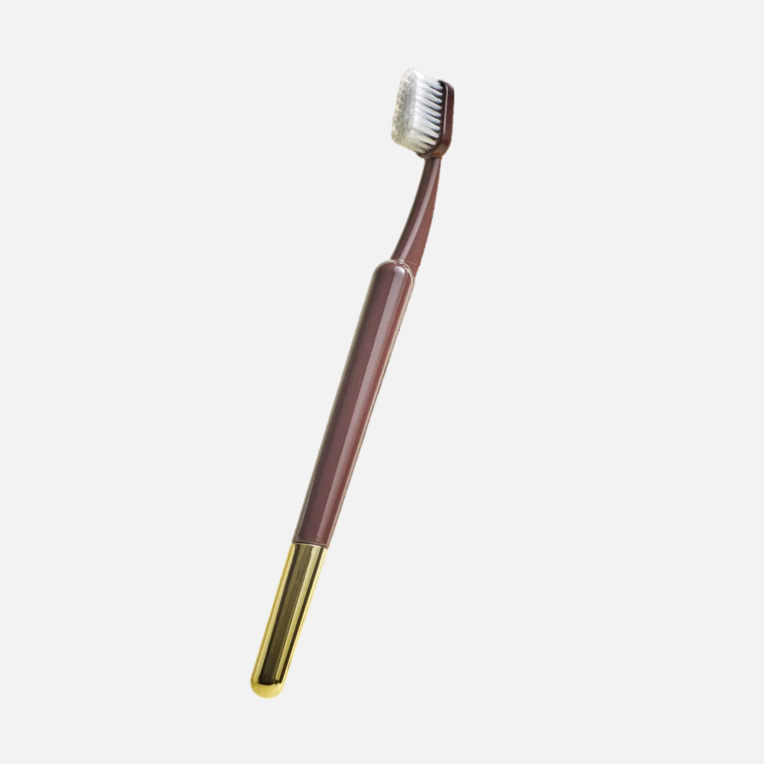 Brown and gold toothbrush on a white background