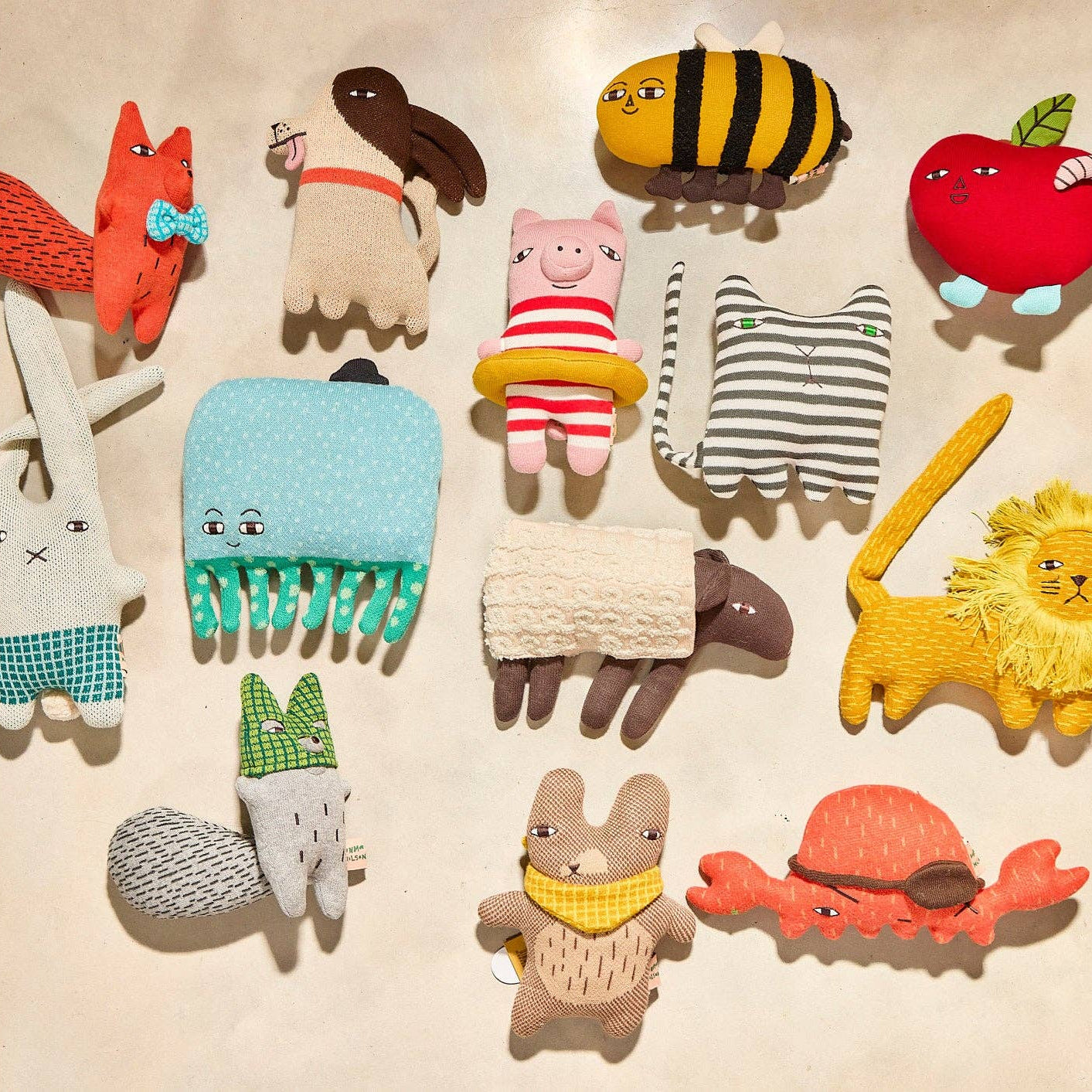 Collection of colorful animal-themed combs on a beige background