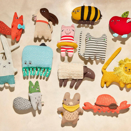 Collection of colorful animal-themed combs on a beige background