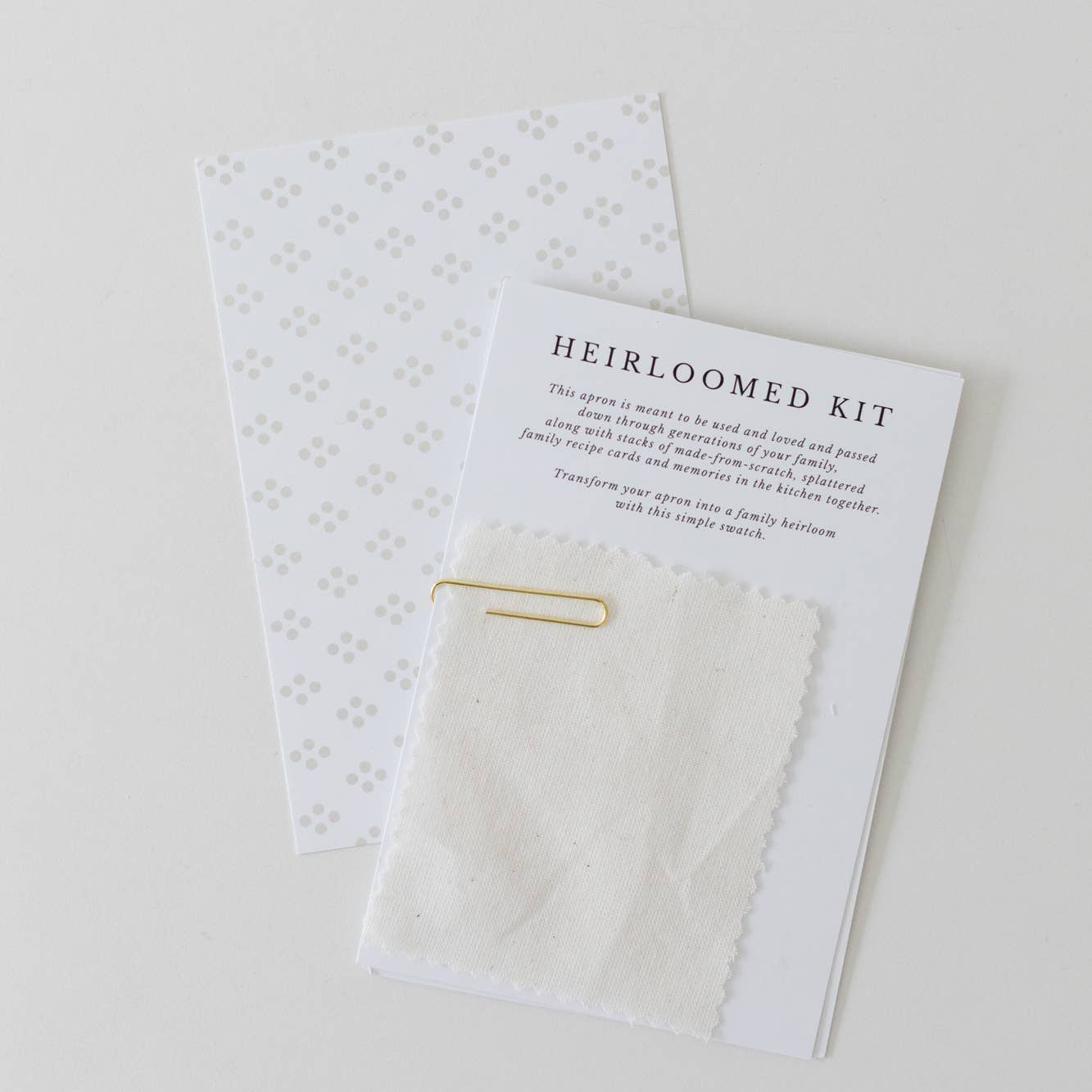 Heirloomed kit with a card and small items on a white background