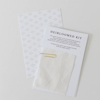 Heirloomed kit with a card and small items on a white background