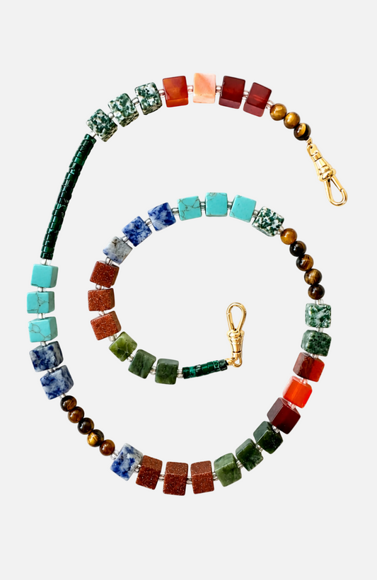 A beaded stretch bracelet or necklace featuring a variety of colorful square and round beads in turquoise, green, blue, red, orange, brown, and white, with gold-tone metal clasps, arranged in a spiral on a white background.